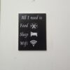 A decorative wall hanging with humorous text.